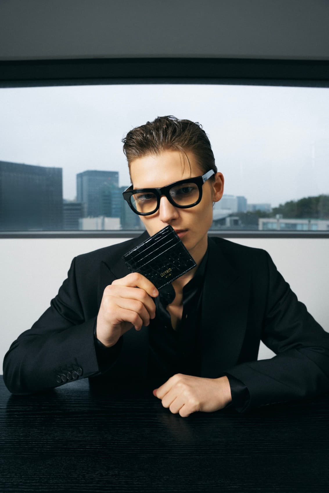 A man carrying the Luster — at a desk