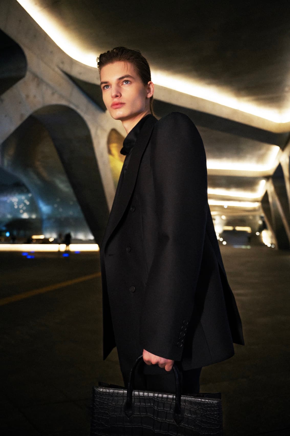 A man carrying the Nocturne — architecture at night
